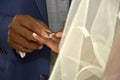 Black couple exchanging wedding rings