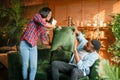 Black couple having fun on sofa, pillow fight Royalty Free Stock Photo