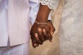 Black couple holding hands during marriage