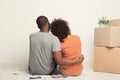 Black couple looking up, sitting on floor Royalty Free Stock Photo