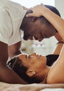 Black couple, love and home bedroom romance while happy and intimate together on bed at home, apartment or hotel. Face Royalty Free Stock Photo