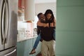 Black couple, piggyback and love while together in home kitchen with care and happiness in a marriage. Happy young man