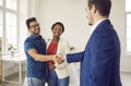 Happy black couple exchanging handshakes with a real estate agent or loan broker Royalty Free Stock Photo