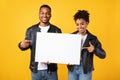 Black Couple Showing Blank Board For Text Over Yellow Background Royalty Free Stock Photo