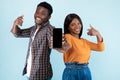 Black couple showing blank empty smartphone screen for mockup Royalty Free Stock Photo