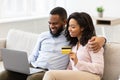 Black couple using computer and debit credit card at home Royalty Free Stock Photo