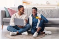 Black couple using computer and debit credit card at home Royalty Free Stock Photo