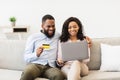 Black couple using computer and debit credit card at home Royalty Free Stock Photo