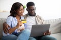 Black couple using pc and credit card at home Royalty Free Stock Photo