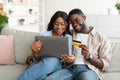Black couple using pc and debit credit card at home Royalty Free Stock Photo