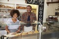 Black couple waiting behind the counter at a sandwich bar Royalty Free Stock Photo