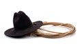 Black cowboy hat and lasso on white