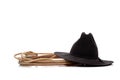 Black cowboy hat and lasso on white