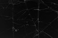 Black cracked glass texture background. Crack on the glass. Broken screen. Broken dark phone. White cracks in glass