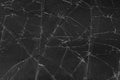 Black cracked glass texture background. Crack on the glass. Broken screen. Broken dark phone. White cracks in glass