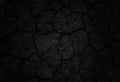 Black cracked surface of grey soil texture background, dark dried and chopped gray earth, old fissure dark ground, close-up, Royalty Free Stock Photo