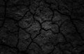 Black cracked surface of grey soil texture background, dark dried and chopped gray earth, old fissure dark ground, close-up, Royalty Free Stock Photo