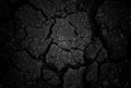 Black cracked surface of grey soil texture background, dark dried and chopped gray earth, old fissure dark ground, close-up, Royalty Free Stock Photo