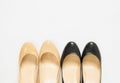 Black and cream heeled women`s shoes on white background.