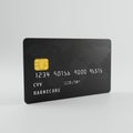 A black credit card features a yellow chip on the left side and a series of embossed numbers and letters