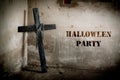 Black cross against the wall with hanging steel chain, Halloween