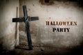 Black cross against the wall with hanging steel chain, Halloween party festival posture advertising. Halloween`s Day and ghost