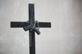 Black cross with chain and handgun on white grunge wall. Object and weapon concept. Christian religion theme. Halloween and