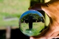 Black cross stone cemetery photography in clear crystal glass ball. Royalty Free Stock Photo