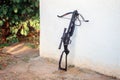 A black crossbow stands near the wall in the courtyard. Preparing weapons for hunting