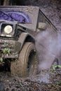 Black crossover driving with cloud of smoke through dirt. Royalty Free Stock Photo