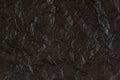 Black crumpled paper texture with folds, black background. Royalty Free Stock Photo