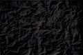 Black crumpled paper texture with folds, black background, wallpaper Royalty Free Stock Photo