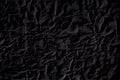 Black crumpled paper texture with folds, black background, wallpaper Royalty Free Stock Photo