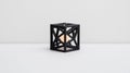 A black cube-shaped lamp with a white light inside. Royalty Free Stock Photo