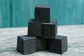 cubes of coal in a heap lie on a gray table Royalty Free Stock Photo
