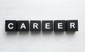 Black cubes with word CAREER on wooden background, flat lay