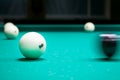Black cue ball striking white balls with number 6. Russian pyramid (Russian billiard, pyramid billiards), cue sport. Royalty Free Stock Photo