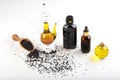 Black cumin oil with seeds on wooden background. glass bottle of black cumin seeds essential oil , Nigella Sativa in spoon and Royalty Free Stock Photo