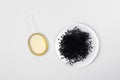 Black cumin oil in spoon and Nigella Sativa or kalonji seeds on white isolated background. The concept of organic herbal medicine Royalty Free Stock Photo