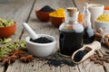 Black cumin or roman coriander seeds, black caraway oil bottles and aromatic spices. Ingredients for cooking. Ayurveda tr Royalty Free Stock Photo