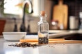 black cumin seed oil in a bottle with black seeds spilled around Royalty Free Stock Photo