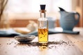 black cumin seed oil in a bottle with black seeds spilled around Royalty Free Stock Photo