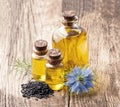 Black cumin seed and oil on wooden Royalty Free Stock Photo