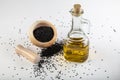 Black cumin seeds in bowl and essential oil in glass bottle. Nigella sativa isolated on white background Royalty Free Stock Photo