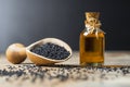 Black cumin seeds essential oil , Nigella Sativa in spoon on wooden background Royalty Free Stock Photo