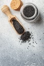 Black cumin seeds on a wooden spoon and in a glass jar Royalty Free Stock Photo