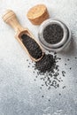 Black cumin seeds on a wooden spoon and in a glass jar Royalty Free Stock Photo