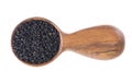 Black cumin seeds in wooden spoon, isolated on white background. Heap of black nigella seeds. Nigella sativa. Top view. Royalty Free Stock Photo