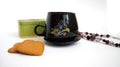 Black cup, beads, green casket and ginger biscuits Royalty Free Stock Photo