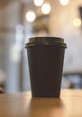 Black Cup with coffee to take away on bokeh background, mock up Royalty Free Stock Photo